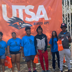 Six teenagers posing for a photo next to a University of Texas at San Antonio logo.